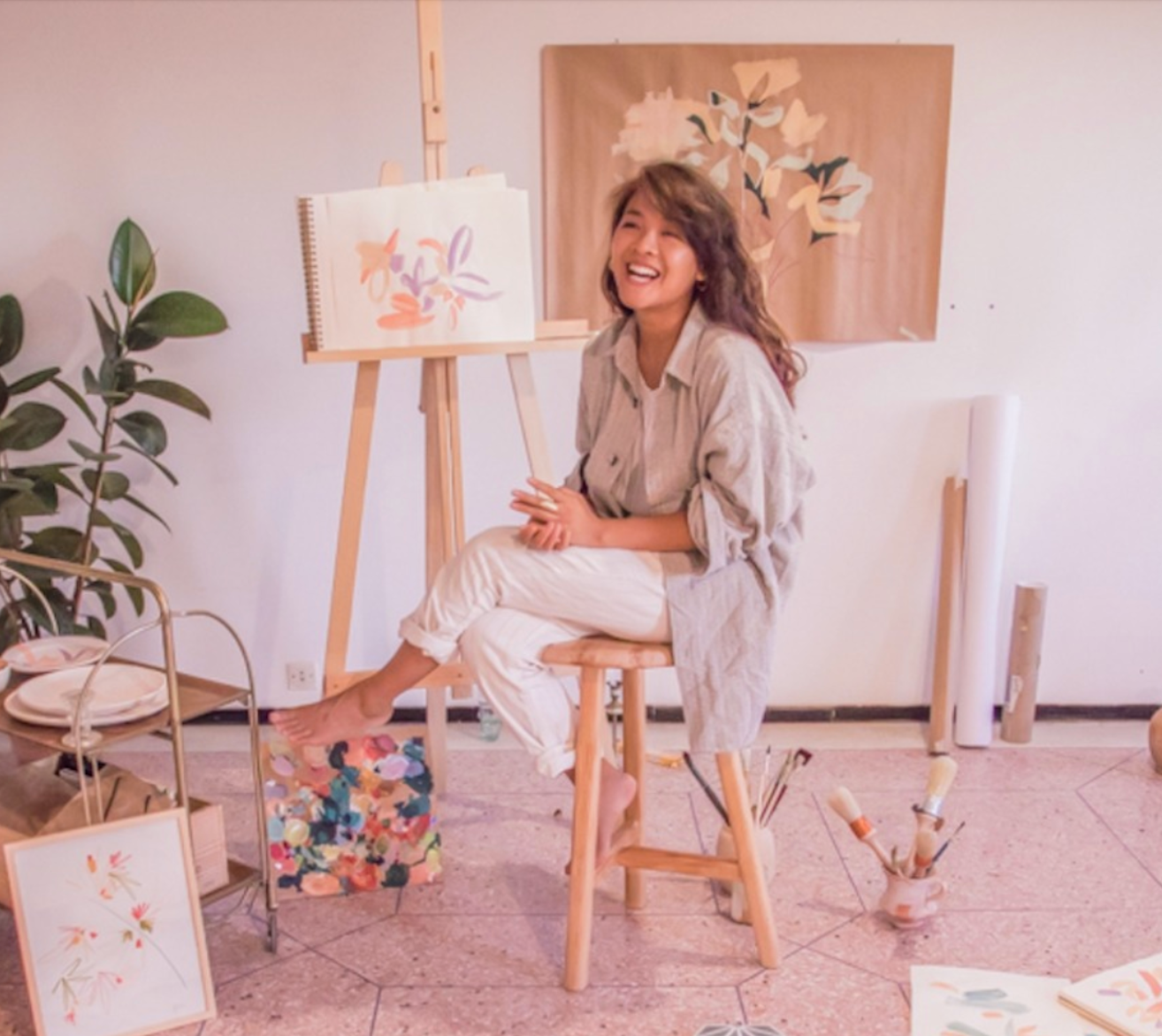 Lucy in her studio surrounded by her paintings