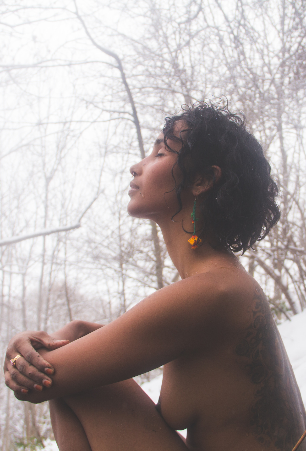 Seated portrait among bare trees